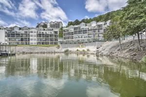 a large apartment building next to a body of water at Waterfront Condo on Lake of the Ozarks with 2 Pools! in Camdenton