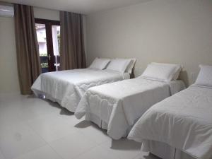 מיטה או מיטות בחדר ב-Pousada Ariús