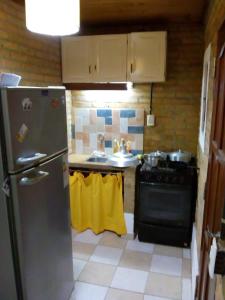 a kitchen with a refrigerator and a sink at DEPARTAMENtO LOFT in Posadas