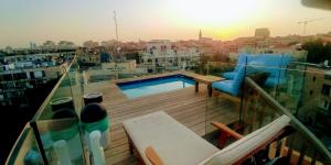 a balcony with a swimming pool on top of a building at Old Jaffa's Penthouse Boutique Hostel in Tel Aviv