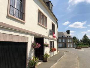 a building with flowers on the side of it at No 6 B&B in Landivy