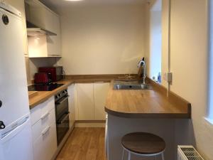 a kitchen with a sink and a counter top at Laundry Cottage in Dumfries