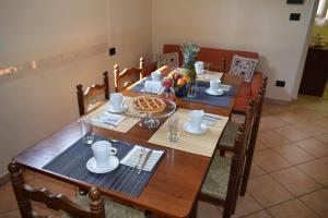 un tavolo in legno con sedie e una sala da pranzo di Affittacamere Villa Paolina a Sala Consilina
