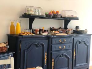 a blue cabinet with food on top of it at No 6 B&B in Landivy