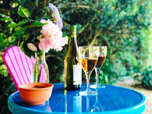 a table with two bottles of wine and two glasses at No 6 B&B in Landivy