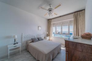 a bedroom with a bed and a ceiling fan at Expoholidays - Apartamento Crucero in Aguadulce