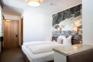 Postel nebo postele na pokoji v ubytování Hotel Bergland Superior