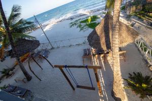 an aerial view of a beach with a swing at The African Paradise Beach Hotel in Bwejuu