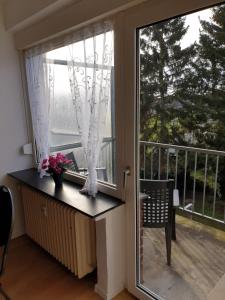 a room with a window and a table with flowers at Ferienwohnung Linden in Willich