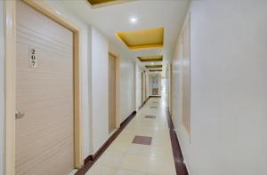 a corridor of a building with white walls and a door at Hotel Mahadev Palace in Deoghar