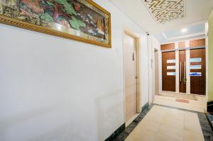 a hallway with a painting on the wall and a door at Hotel Mahadev Palace in Deoghar