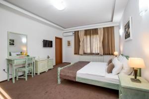 Voodi või voodid majutusasutuse Hotel Trim toas