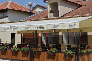 a restaurant with plants on the facade of a building at Hotel Trim in Nikšić