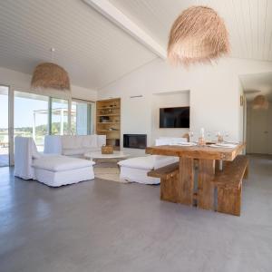 a living room with a table and a couch at Campo de Arroz in Carvalhal