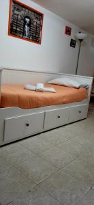 a bedroom with a bed with an orange blanket on it at B&B Porta Nuova in Palermo