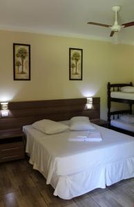 Säng eller sängar i ett rum på Camping e Pousada Paiol