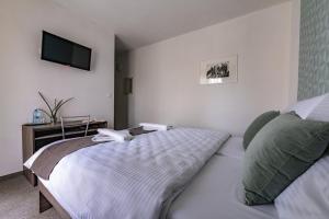 A bed or beds in a room at Penzión pod brezami**