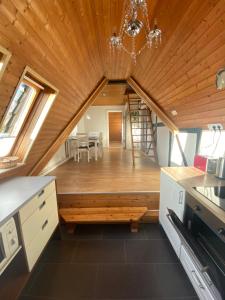 a kitchen with a wooden ceiling and a dining room at Ferienwohnung Kanalblick in Schacht-Audorf