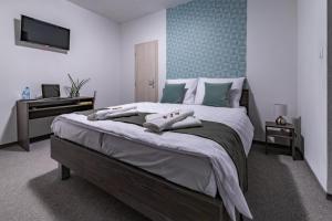 A bed or beds in a room at Penzión pod brezami**