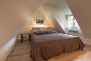 En eller flere senger på et rom på Cottage Normand