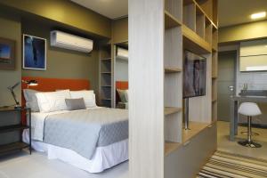 a bedroom with a bed and a wall with shelves at #2 Sofisticado Estúdio na Boaventura da Silva in Belém