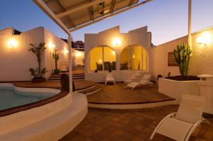 a villa with a swimming pool and a patio at Terrace on the Beach in Telde
