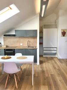 a kitchen with a white table and chairs in a room at SkyEscaPe Pescara Centro in Pescara