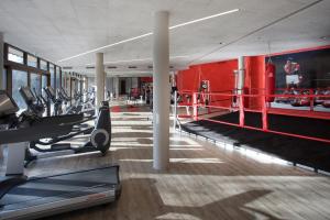 a gym with several treadmills and a boxing at Feuriger Tatzlwurm in Oberaudorf
