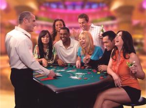 a group of people standing around a poker table at Bally's Dover in Dover