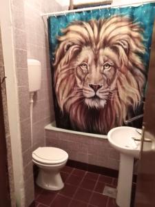 a bathroom with a painting of a lion shower curtain at Apartmani Lav in Sutomore +127 photos