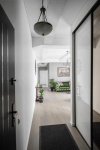 an open hallway with a door and a living room at KM apartamentai in Kaunas