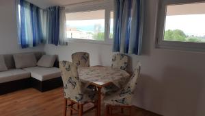 a living room with a table and chairs and a couch at Penthaus Cacao Beach in Sunny Beach