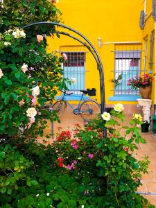 a bike parked in front of a yellow building with flowers at A&S FerienwohnungenBonner str 49 in Bonn