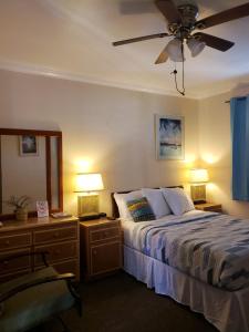 una camera con un letto e due comodini con lampade di Midtown Guest House a Charlotte Amalie