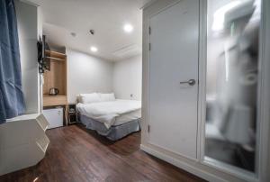 a bedroom with a bed and a sliding glass door at MAYONE HOTEL Myeongdong in Seoul