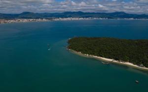 an island in the middle of a large body of water at Innbox - Porto Belo in Porto Belo
