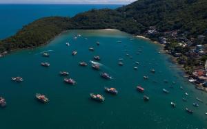 an aerial view of a group of boats in the water at Innbox - Porto Belo in Porto Belo