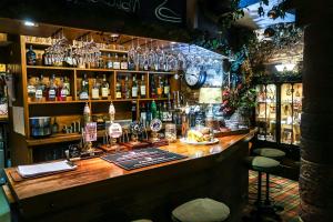 a bar with a lot of bottles of alcohol at The Black Swan in Ravenstonedale