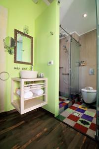 
a bathroom with a shower, sink, and toilet at Elia Fatma Boutique Hotel in Chania Town
