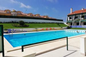 a large swimming pool in front of a building at Pedra do Ouro Yoga Retreat apartment in Pataias