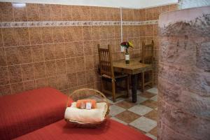 a room with a bed and a table and a chair at Casa Lupita Hostel in Guanajuato