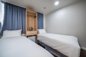 Postel nebo postele na pokoji v ubytování MAYONE HOTEL Myeongdong