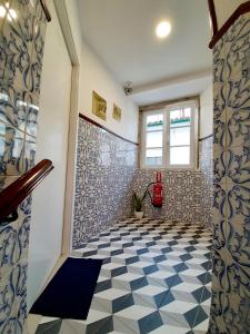 a bathroom with a black and white tiled floor at Residenza Dutzu - Aparthotel Leiria in Leiria +79 photos