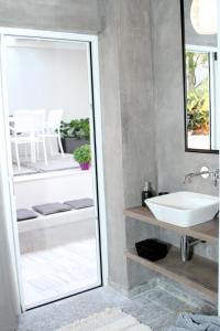 a bathroom with a sink and a mirror at Cretan Luxury Villa by Smaris Collection in Kokkíni Khánion