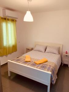 a bedroom with a bed with two orange towels on it at BEAUTIFUL PRIVATE in Beer Sheva