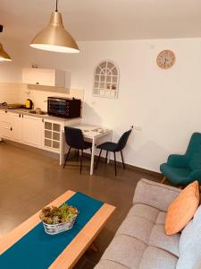 a living room with a couch and a table and a kitchen at BEAUTIFUL PRIVATE in Beer Sheva