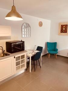a kitchen with a table and chairs and a microwave at BEAUTIFUL PRIVATE in Beer Sheva