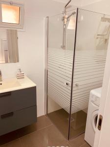 a bathroom with a shower and a sink and a washing machine at BEST BEAUTIFUL PRIVATE in Beer Sheva