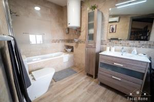 a bathroom with a toilet and a sink and a tub at Casa Rural La Zzinetina con Jacuzzi in Constantina