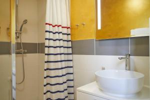 a bathroom with a sink and a shower at HOTEL Les Contes de Bruyeres in Servières-le-Château +11 photos